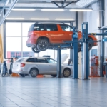 Female,mechanic,checks,diagnostics,results,on,a,tablet,computer,and